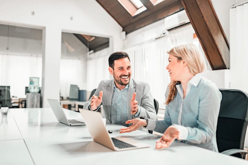 Zwei Businesskollegen arbeiten am Laptop im Coworking Büro